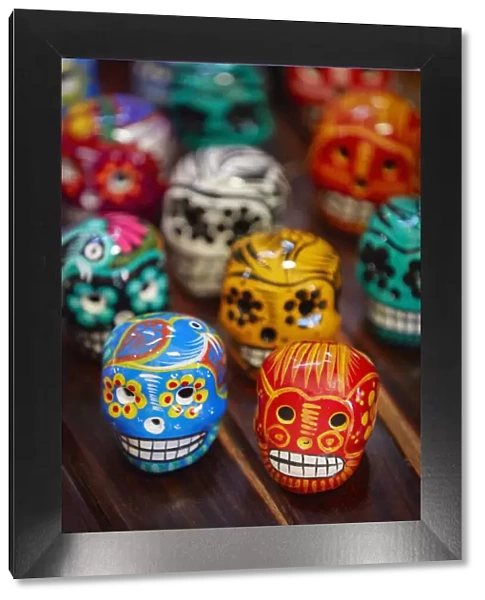 Colorful Mexican skullls (Calaca) on sale in a souvenir shop of the Campeche historical cask, Yucatan, Mexico. The Calaca is commonly used for decoration during the Mexican Day of the Dead festival