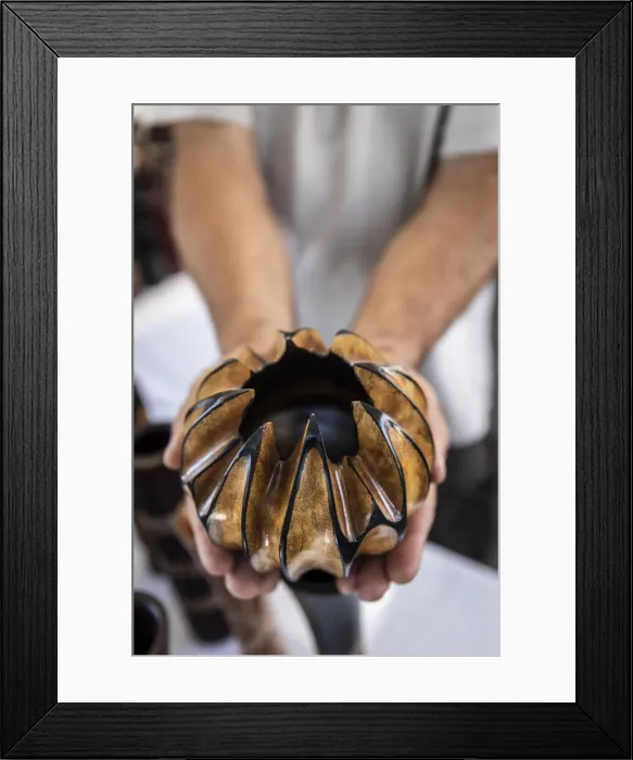 Framed Print : France, Reunion Island, Saint Paul, Stand keeper showing an handcraft object in Saint Paul market Framed Print : France, Reunion Island, Saint Paul, Stand keeper showing an handcraft object in Saint Paul market
