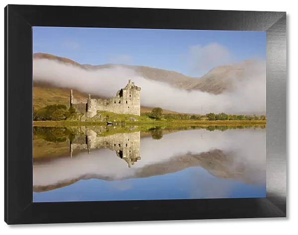 Kilchurn Castle reflected in the perfectly still Loch Awe, Argyll & Bute, Scotland. Autumn (October) 2010