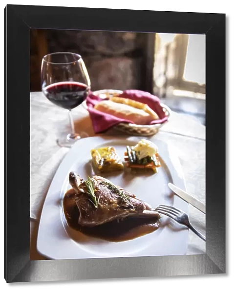 Spain, Canary Islands, Fuerteventura, Betancuria, A plate of roasted goat with rosemary sauce and potatoes mille-feuille