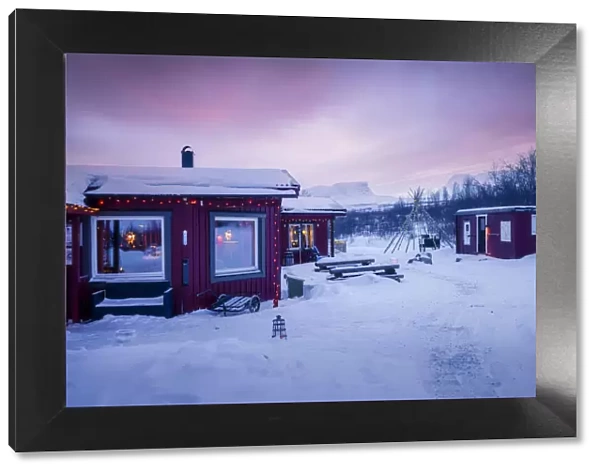 Typical village in the Arctic Circle, Swedish Lapland, Abisko. Christmas time at sunset