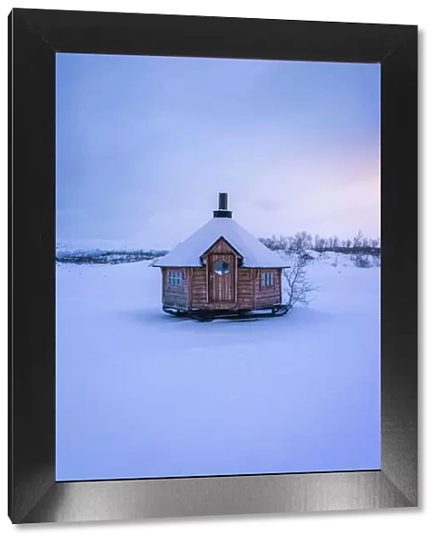 little wooden hut on the iced lake Tornetrask, Arctic Circle. Abisko National Park, Swedish Lapland, Sweden