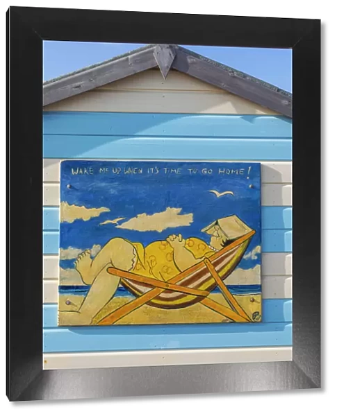 England, Hampshire, Hayling Island, Funny Painting of Fat Lady Asleep in Deck Chair on side of Colourful Beach Hut