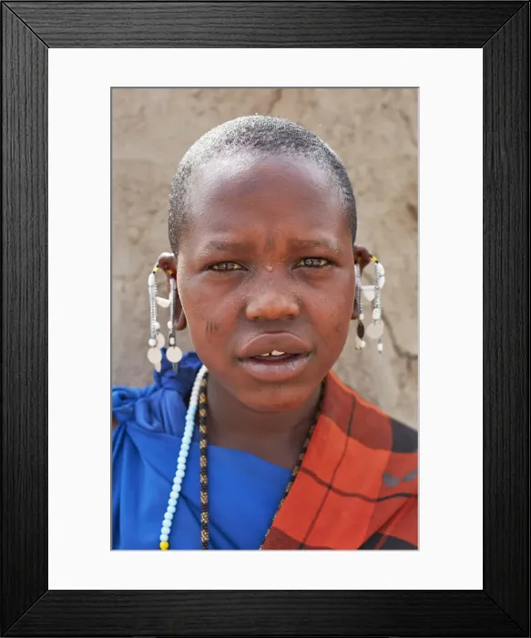 Framed Print : Portrait of a young Msai girl with a traditional Shuka dress in a village near Arusha, Tanzania, Africa Framed Print : Portrait of a young Msai girl with a traditional Shuka dress in a village near Arusha, Tanzania, Africa