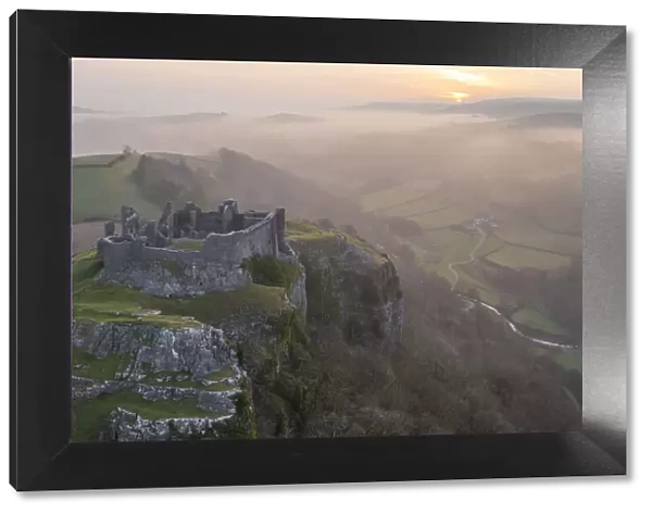 Carreg Cennen Castle at sunrise on a misty early Spring morning, Brecon Beacons National Park, Carmarthenshire, Wales. Spring (March) 2022