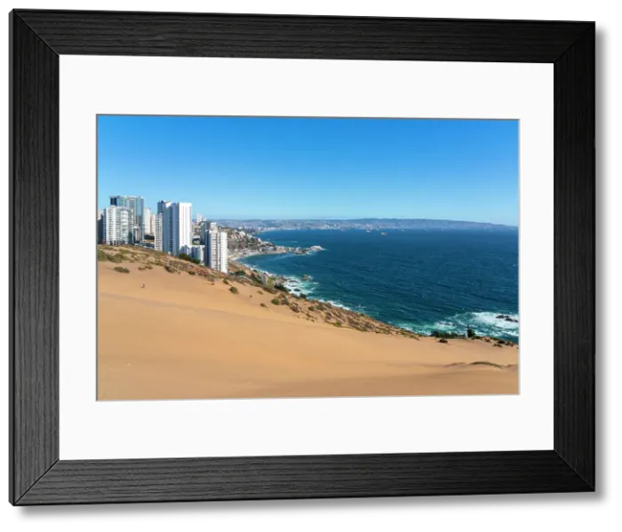 Framed Print : Sand dunes with high-rise buildings on coast and distant view of Vina del Mar and Valparaiso, Concon, Valparaiso Province, Valparaiso Region, Chile Framed Print : Sand dunes with high-rise buildings on coast and distant view of Vina del Mar and Valparaiso, Concon, Valparaiso Province, Valparaiso Region, Chile