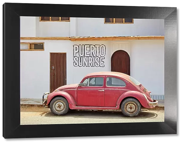 A red Volkswagen Beetle in front of a house in Puerto Eten, Chiclayo, Lambayeque, Peru