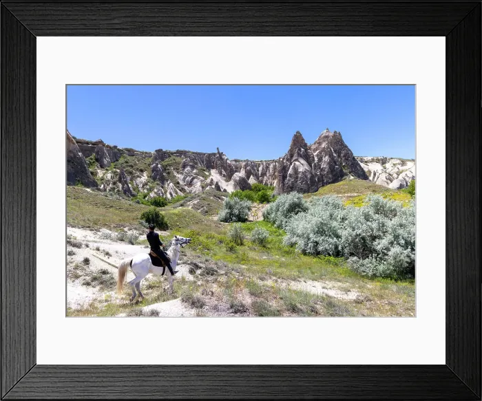 Framed Print : A man rides a horses through Cappadocia, Nevsehir Province, Central Anatolia, Turkey Framed Print : A man rides a horses through Cappadocia, Nevsehir Province, Central Anatolia, Turkey