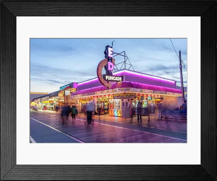 Framed Print : Wildwood, New Jersey. Illuminated stores along the boadwalk at dusk. The Wildwood beach and its boardwalk are a popular resort destination Framed Print : Wildwood, New Jersey. Illuminated stores along the boadwalk at dusk. The Wildwood beach and its boardwalk are a popular resort destination