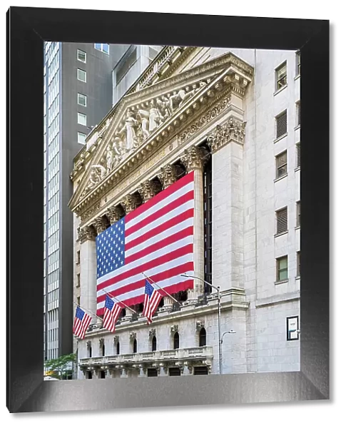 The facade of New York Stock Exchange (NYSE) building adorned with the US flag, Wall Street, Lower Manhattan, New York, USA