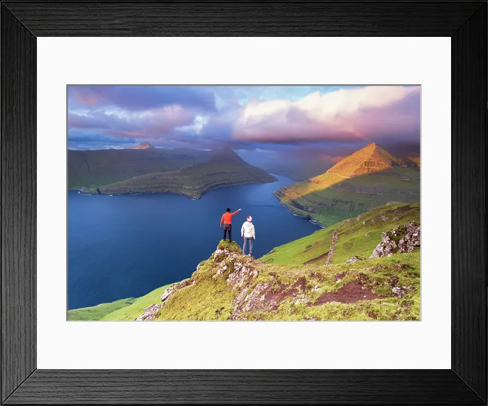 Framed Print : Two hikers on top of a rock admiring the fjord of Funningur at sunrise, Eysturoy island, Faroe islands, Denmark (MR) Framed Print : Two hikers on top of a rock admiring the fjord of Funningur at sunrise, Eysturoy island, Faroe islands, Denmark (MR)