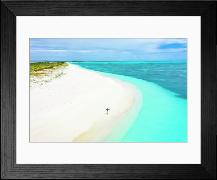 Framed Print : Cheerful man with arms outstretched admiring the sea standing on a white sand beach, aerial view, Antigua & Barbuda, Caribbean (MR) Framed Print : Cheerful man with arms outstretched admiring the sea standing on a white sand beach, aerial view, Antigua & Barbuda, Caribbean (MR)