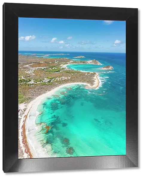 Clear summer sky over the white sand beach overlooking the crystal water of Caribbean Sea, aerial view, Antigua, West Indies