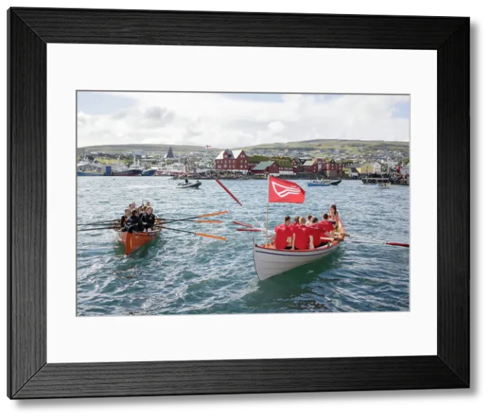 Framed Print : Rowing boats after a competion in occasion of lavsoka festival in the city of Torshavn. In the background the red buildings of Tinganes. Island of Streymoy. Faroe Islands