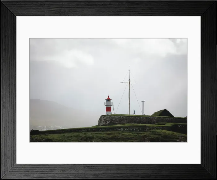 Framed Print : A person walking towards Skansin lighthouse in Torshavn. Faroe Islands Framed Print : A person walking towards Skansin lighthouse in Torshavn. Faroe Islands