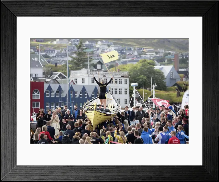 Framed Print : Rowing boat team celebrating the win after a competion in occasion of lavsoka festival in the city of Torshavn. In the background the red buildings of Tinganes. Island of Streymoy. Faroe Islands Framed Print : Rowing boat team celebrating the win after a competion in occasion of lavsoka festival in the city of Torshavn. In the background the red buildings of Tinganes. Island of Streymoy. Faroe Islands