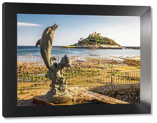 Dolphin statue overlooking St Michael`s Mount, Marazion, Cornwall, England