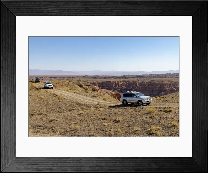 Framed Print : Kazakhstan, Charyn Canyon, 4-wheel drives travel through the canyon Framed Print : Kazakhstan, Charyn Canyon, 4-wheel drives travel through the canyon