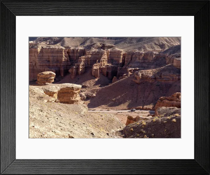 Framed Print : Kazakhstan, Charyn Canyon, an old bus drives through the canyon