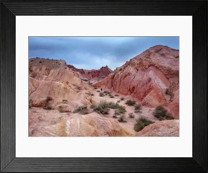 Framed Print : Kyrgyzstan, Issyk Kul Lake, Fairytale canyon (Skazka canyon), a person walks through the red canyon Framed Print : Kyrgyzstan, Issyk Kul Lake, Fairytale canyon (Skazka canyon), a person walks through the red canyon