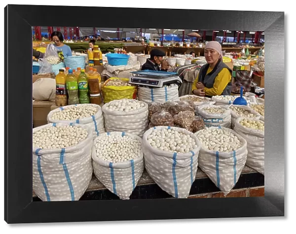 Kyrgyzstan, Bishkek, Osh bazaar, a local woman sells cheese balls