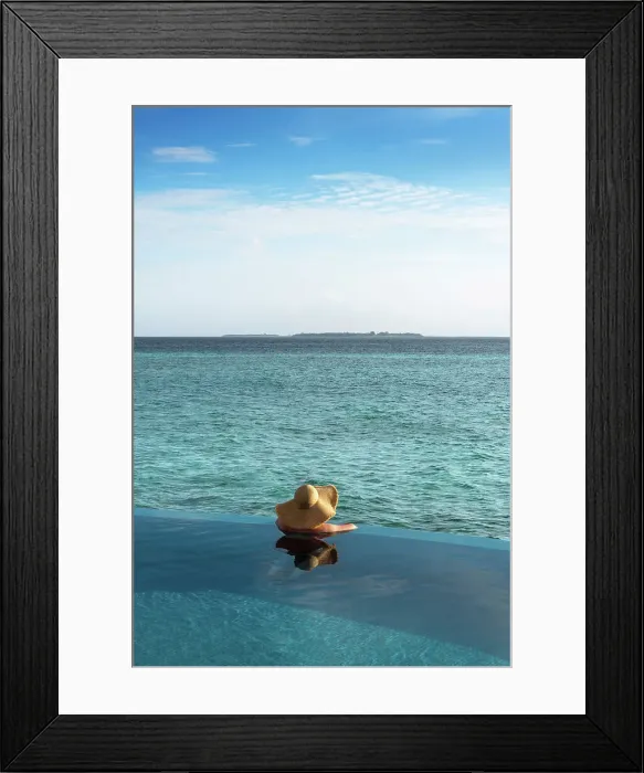 Framed Print : A woman looking at the ocean from the infinity pool, Baa Atoll, Maldives Framed Print : A woman looking at the ocean from the infinity pool, Baa Atoll, Maldives