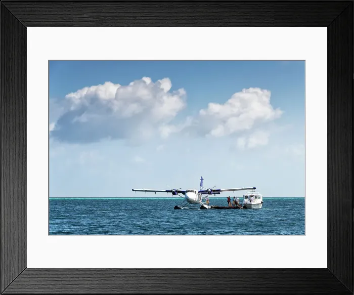 Framed Print : Tourists transfer from a speed boat to a seaplane, Baa Atoll, Maldives Framed Print : Tourists transfer from a speed boat to a seaplane, Baa Atoll, Maldives