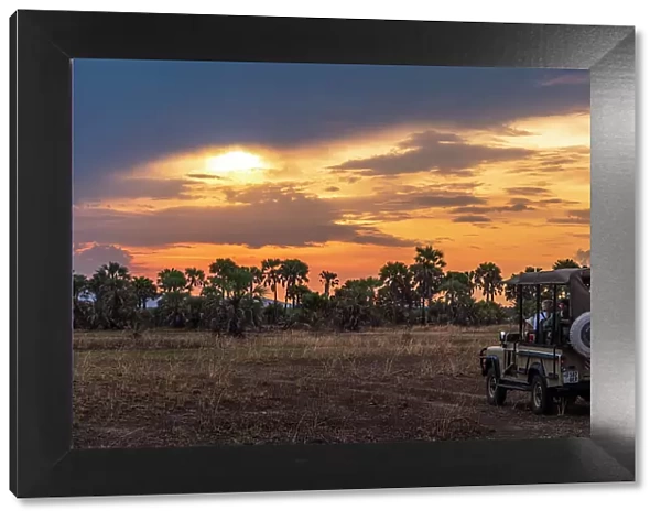 africa, Tanzania, Katavi National Park. A safari car at sunset