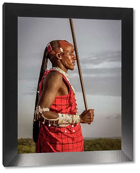 Africa, Tanzania, Manyara Region. Msai warrior posing with his traditional stick