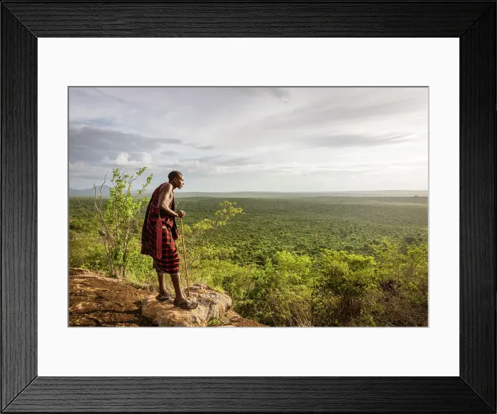 Framed Print : Africa, Tanzania, Manyara Region. Msai man on a rock overlooking the landscape towards the plain of Tarangire National park