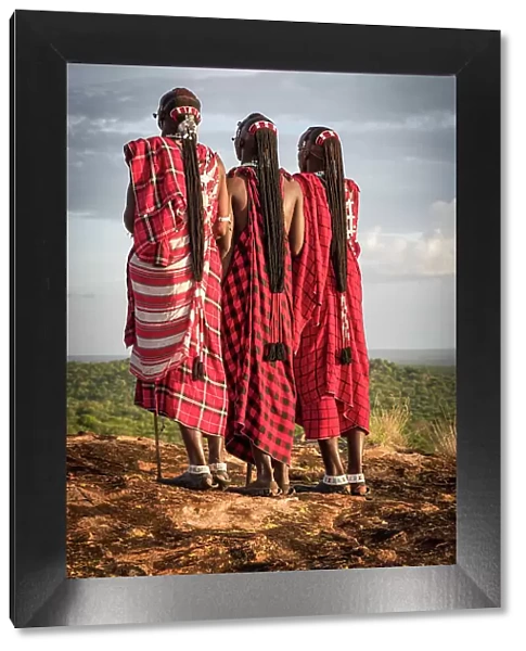 Africa, Tanzania, Manyara Region. Msai warriors on a rock showing their traditional braids