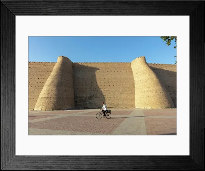 Framed Print : Uzbekistan, Bukhara, UNESCO world heritage site, Ark Fortress, a man cycles past the city walls Framed Print : Uzbekistan, Bukhara, UNESCO world heritage site, Ark Fortress, a man cycles past the city walls