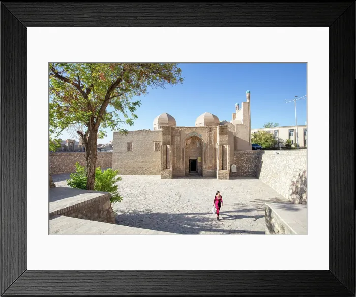 Framed Print : Uzbekistan, Bukhara, a woman walks past a small mosque in central Bukhara Framed Print : Uzbekistan, Bukhara, a woman walks past a small mosque in central Bukhara
