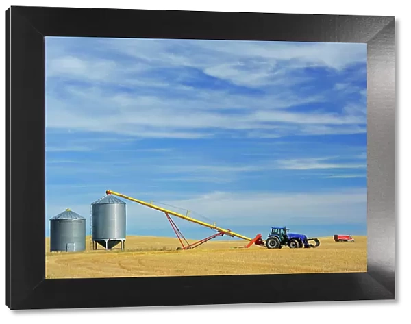 Grain bins, tractor and auger near Beechy Saskatchewan, Canada