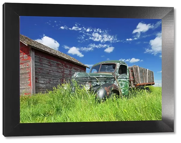 Old International truck and wodden grainery on farm Hazenmore Saskatchewan, Canada