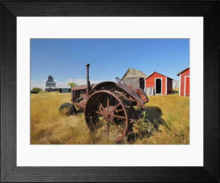 Framed Print : Old tractor, sheds and grain elevator in ghost town Fusiller Saskatchewan, Canada Framed Print : Old tractor, sheds and grain elevator in ghost town Fusiller Saskatchewan, Canada