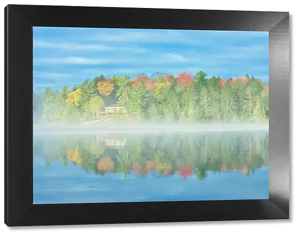 Fog on Horseshoe Lake in autumn with cottage, Near Parry Sound, Ontario, Canada