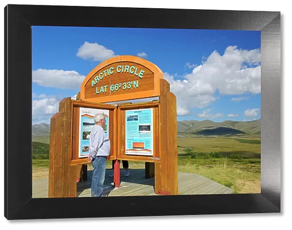 Tourist on the Dempster Highway (KM 405) at the Arctic Circle (model released). Dempster Highway, Yukon, Canada