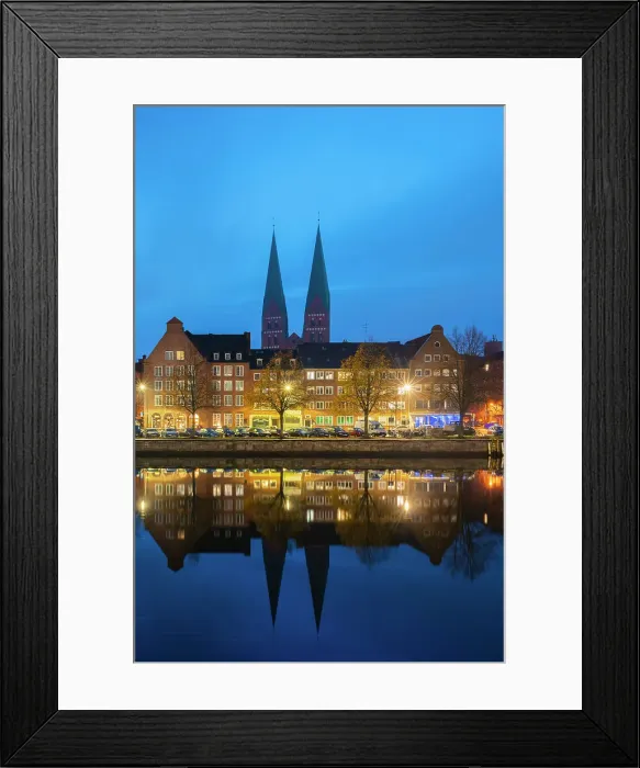 Framed Print : Houses on riverfront of Trave river with towers of St. Marienkirche church in background at twilight, Lubeck, UNESCO, Schleswig-Holstein, Germany