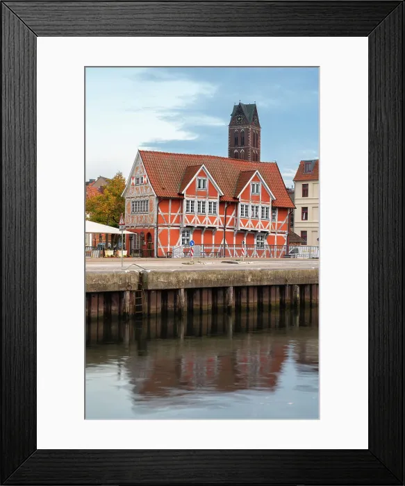 Framed Print : Half-timbered building called Gewolbe (The Vault) and tower of St. Marienkirche church in background, Wismar, UNESCO, Nordwestmecklenburg, Mecklenburg-Western Pomerania, Germany