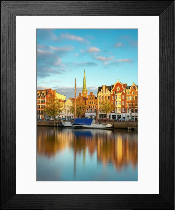 Framed Print : Houses on riverfront of Trave river with tower of St. Jakobi Kirche church in background at sunset, Lubeck, UNESCO, Schleswig-Holstein, Germany Framed Print : Houses on riverfront of Trave river with tower of St. Jakobi Kirche church in background at sunset, Lubeck, UNESCO, Schleswig-Holstein, Germany