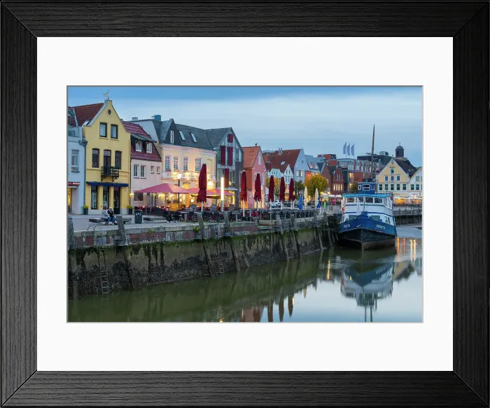 Framed Print : Houses with colorful facades on Hafenstrasse and anchored boat, Husum, Nordfriesland, Schleswig-Holstein, Germany Framed Print : Houses with colorful facades on Hafenstrasse and anchored boat, Husum, Nordfriesland, Schleswig-Holstein, Germany