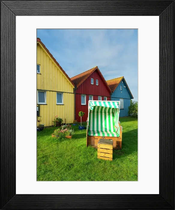 Framed Print : Beach chair in front of colorful houses of Seefohrerhus restaurant, Wittdun harbor, Amrum island, Nordfriesland, Schleswig-Holstein, Germany Framed Print : Beach chair in front of colorful houses of Seefohrerhus restaurant, Wittdun harbor, Amrum island, Nordfriesland, Schleswig-Holstein, Germany