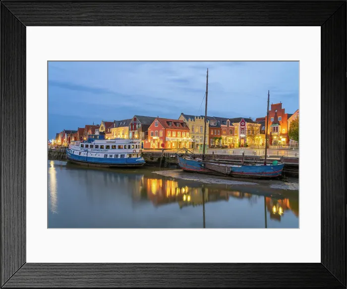 Framed Print : Binnenhafen port with anchored boats and colorful houses at twilight, Husum, Nordfriesland, Schleswig-Holstein, Germany Framed Print : Binnenhafen port with anchored boats and colorful houses at twilight, Husum, Nordfriesland, Schleswig-Holstein, Germany