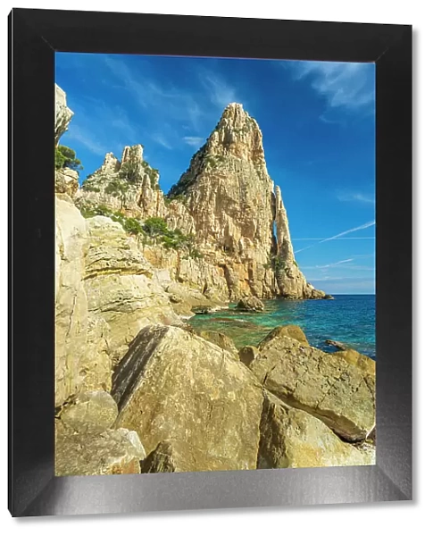 Europe, Italy, Sardinia. On the rocky beach near to the caracteristic rock needle Pedra Longa