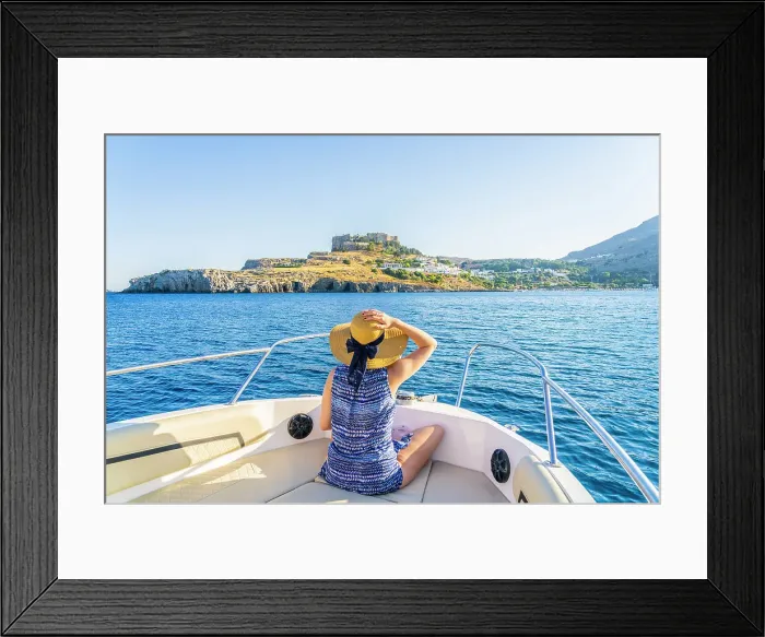 Framed Print : A woman on a boat looking at the Acropolis of Lindos, Lindos, Rhodes, Dodecanese Islands, Greece. (MR)