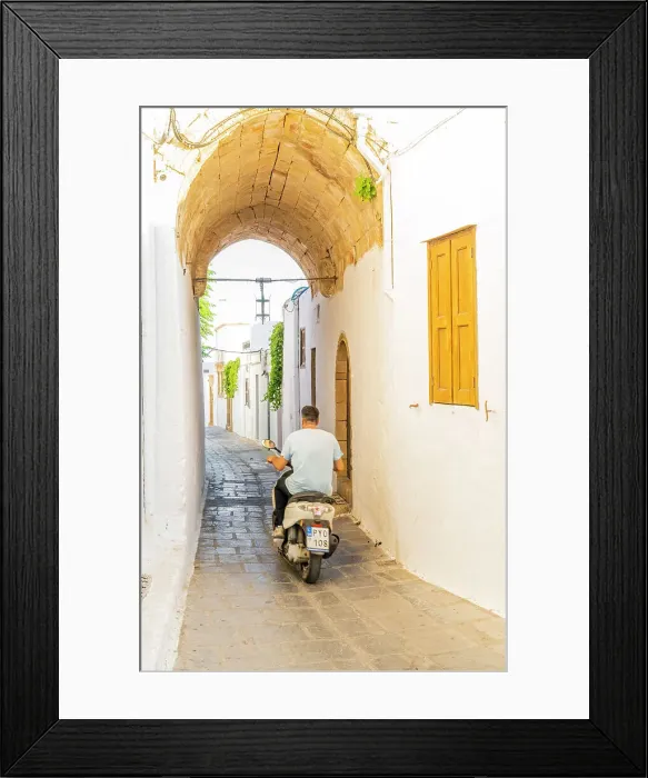 Framed Print : A man on a scooter in Lindos, Rhodes, Dodecanese Islands, Greece Framed Print : A man on a scooter in Lindos, Rhodes, Dodecanese Islands, Greece