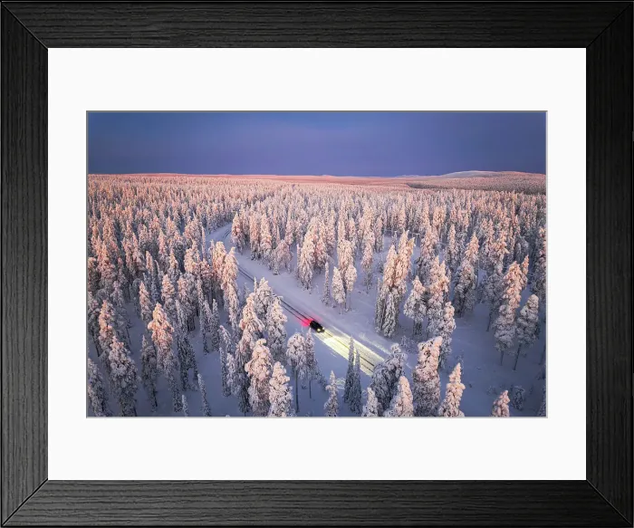 Framed Print : Car traveling on icy road crossing the winter forest covered with snow from above, Lapland, Finland Framed Print : Car traveling on icy road crossing the winter forest covered with snow from above, Lapland, Finland