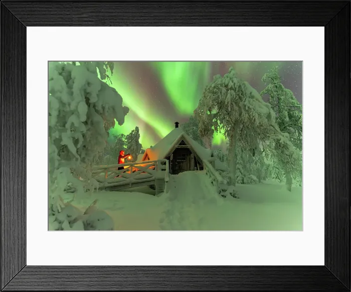 Framed Print : Man with lantern approacching a wooden hut in the snow covered forest under northern lights (aurora borealis), Lapland, Finland (MR) Framed Print : Man with lantern approacching a wooden hut in the snow covered forest under northern lights (aurora borealis), Lapland, Finland (MR)