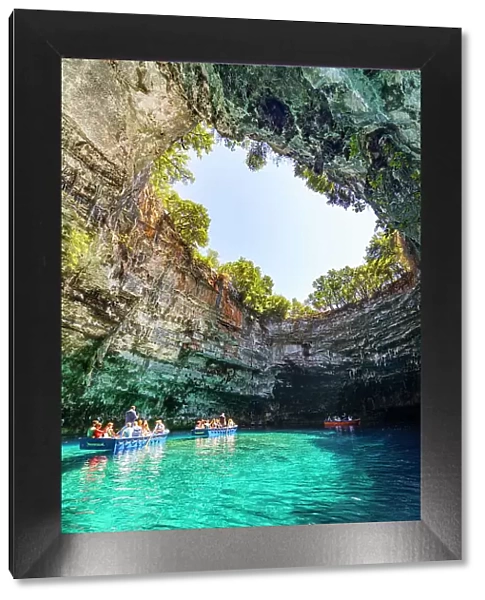 Tourists admiring the cave during a boat trip on the crystal waters of Melissani Lake, Kefalonia, Ionian Islands, Greece